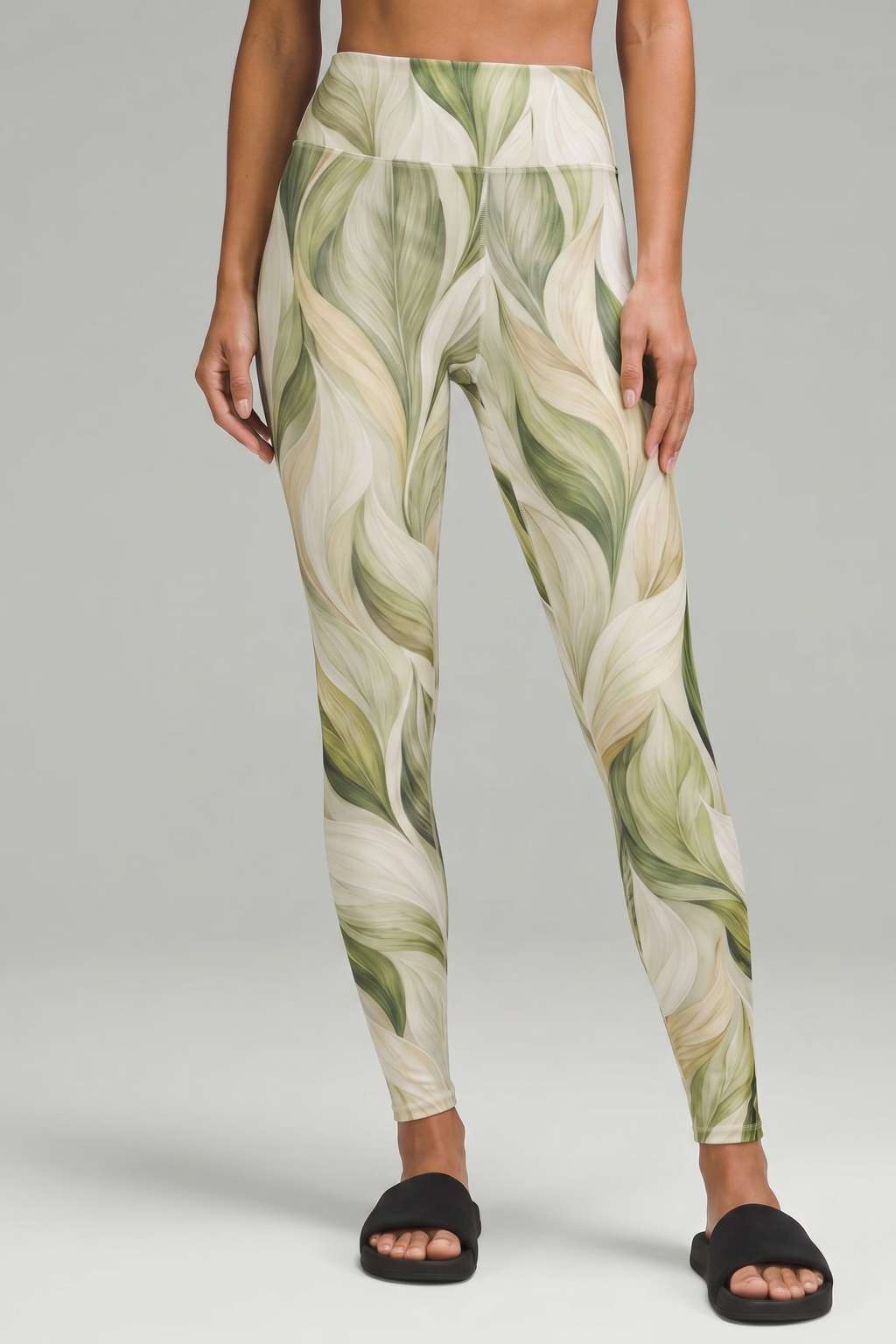 Green leaf-patterned leggings on a gray background