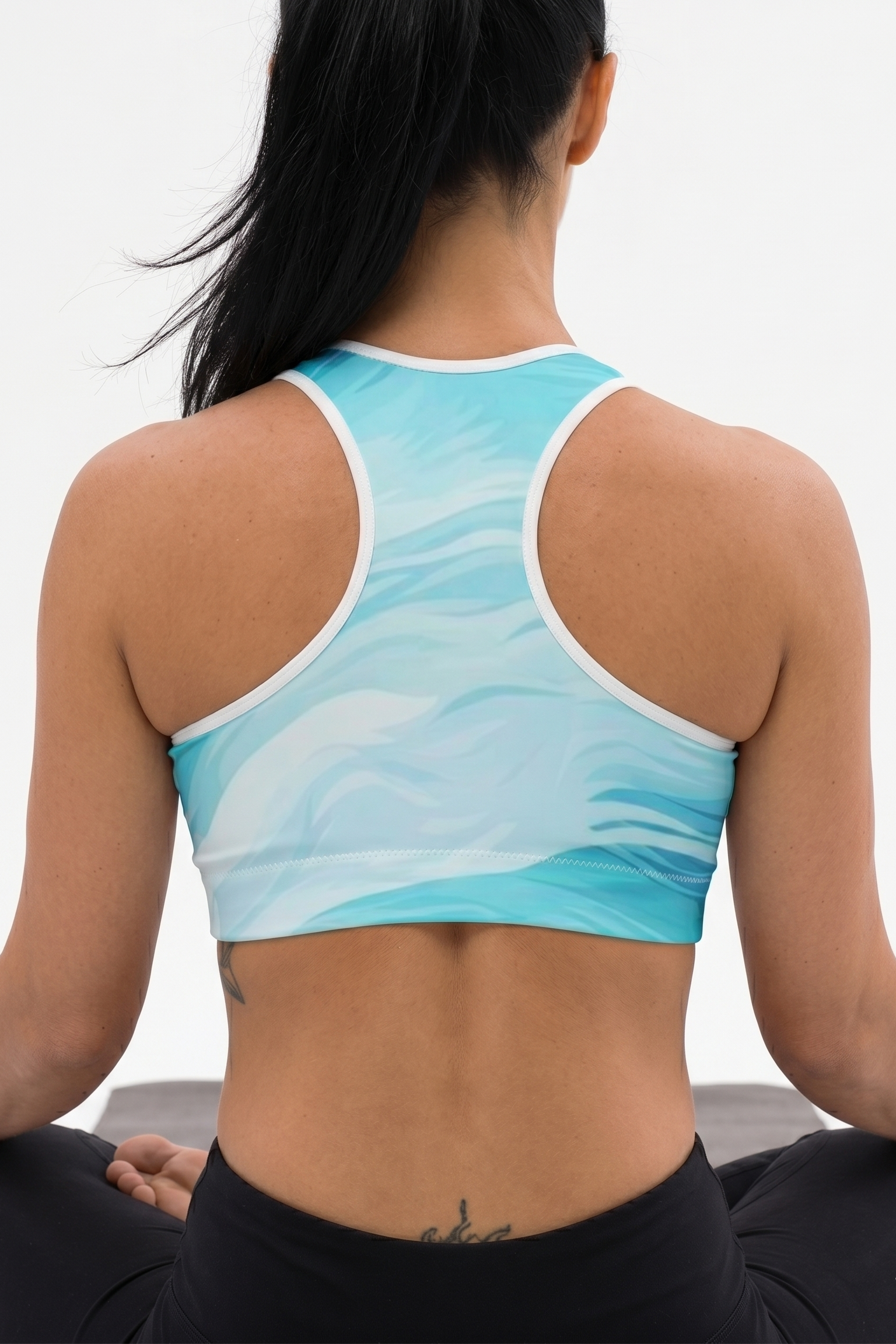 Person wearing a blue sports bra with a white background