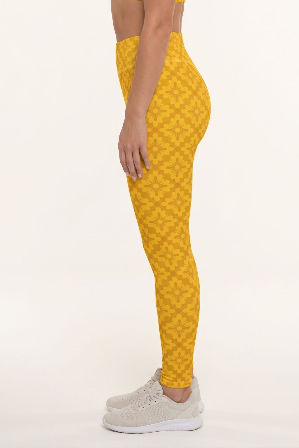 Woman wearing a yellow patterned outfit on a white background