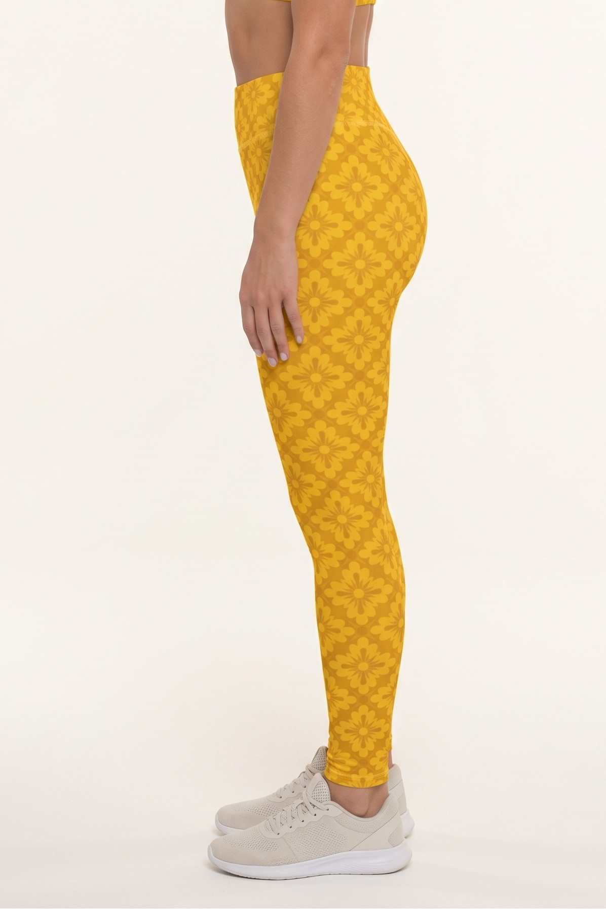 Woman wearing a yellow patterned outfit on a white background