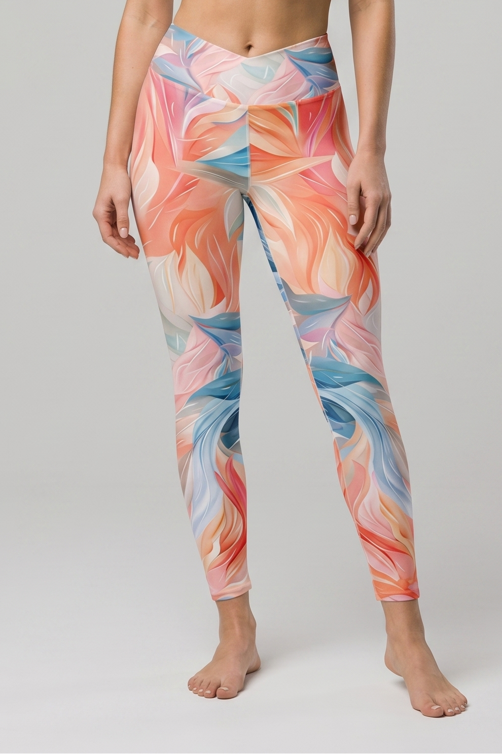 Woman wearing a colorful sports bra and leggings set on a gray background