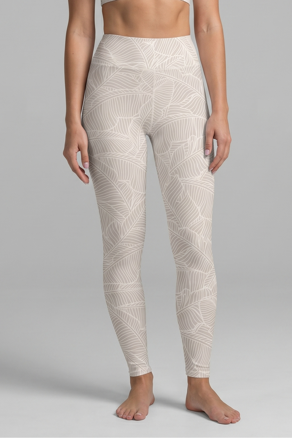Woman wearing a white patterned athletic outfit on a gray background