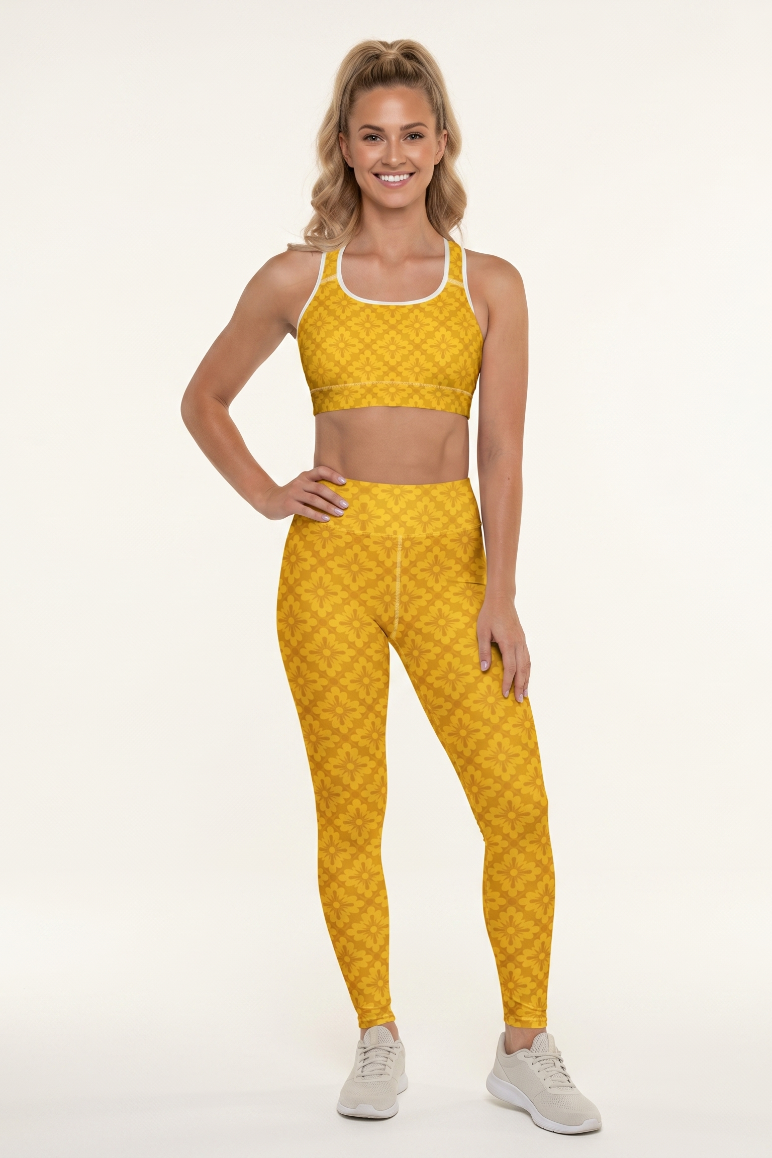 Woman wearing a yellow patterned sports bra and leggings set on a white background