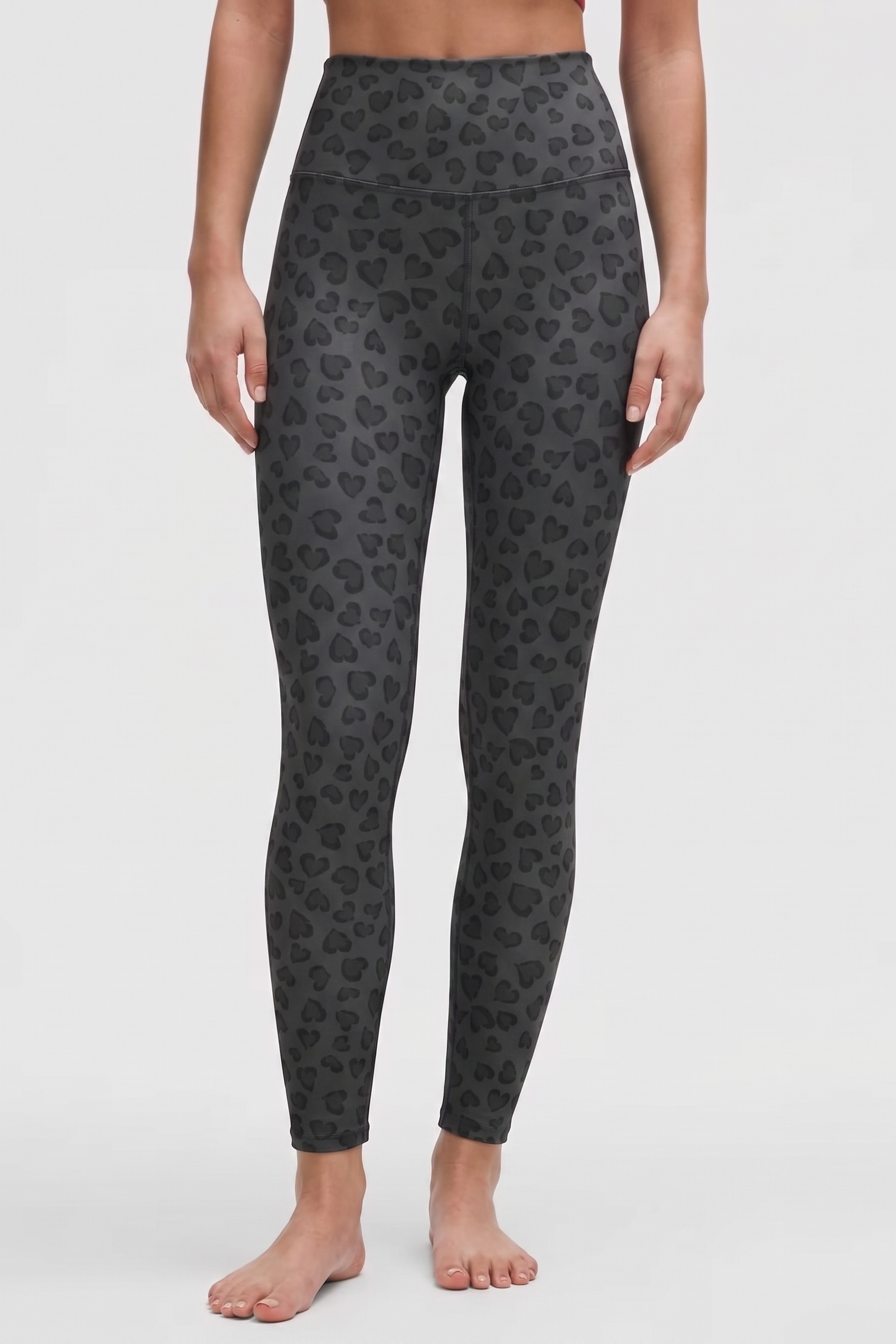 Dark gray leggings with a subtle pattern on a white background