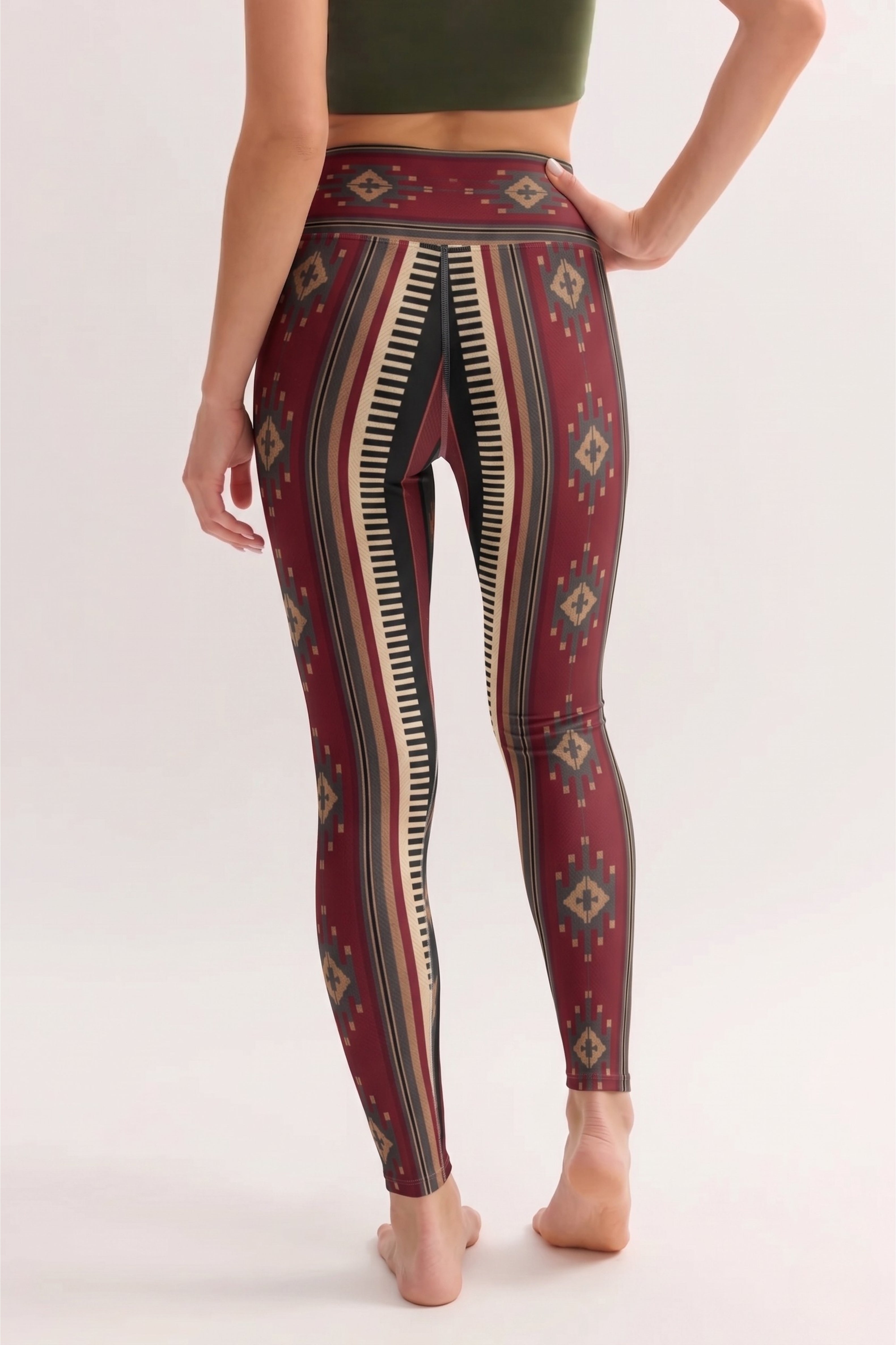 Person wearing maroon leggings with geometric pattern on a white background